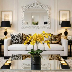 Konstgjord gul orkide med svart kruka placerad på ett tv bord